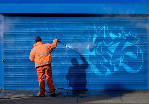 Cold water pressure washer being used to remove graffiti